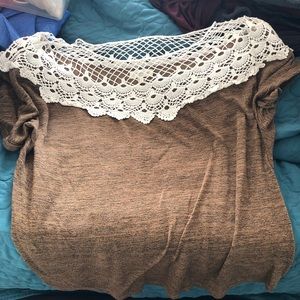 Boutique shirt with white trim at shoulders.